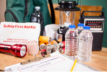 bottled water a torch and other supplies in an emergency kit